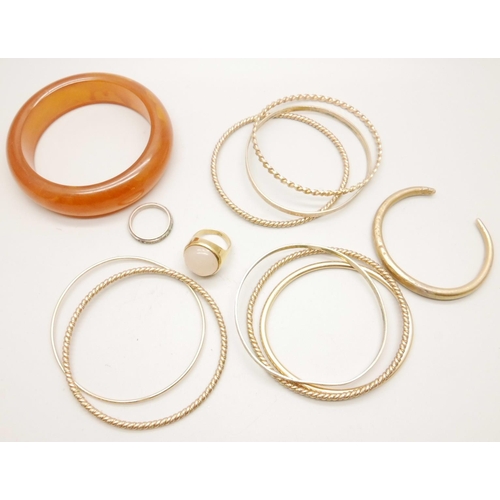 1071 - A collection of gold tone bangles and a ring, and one other bangle