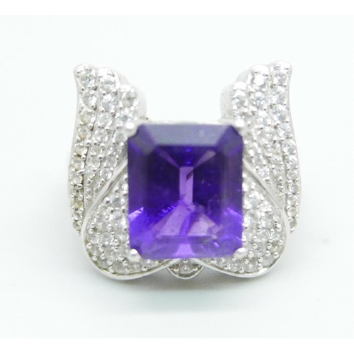 1094 - A silver ring with an amethyst and cubic zirconia set wing detail, size Q, by TJC