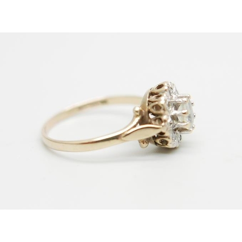 1099 - A 9ct gold ring set with a clear central stone and diamond chip halo, 2.2g, O