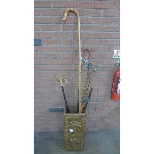 1144 - A brass covered stick stand with seven walking sticks and a crook **PLEASE NOTE THIS LOT IS NOT ELIG... 