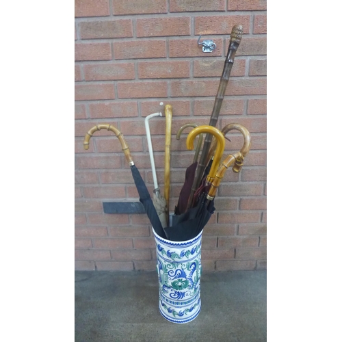 1147 - A ceramic stick stand with a collection of six umbrellas, and three walking sticks **PLEASE NOTE THI... 