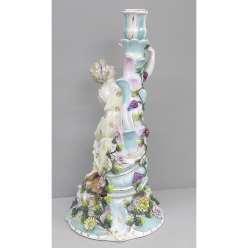 603 - A German porcelain figural candlestick