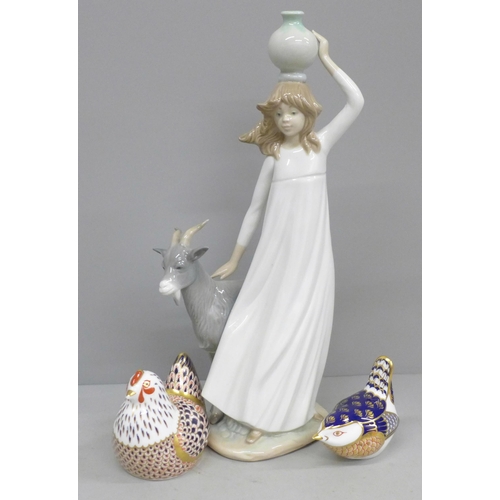 672 - Two Royal Crown Derby paperweights and a Nao figure of a girl with goat