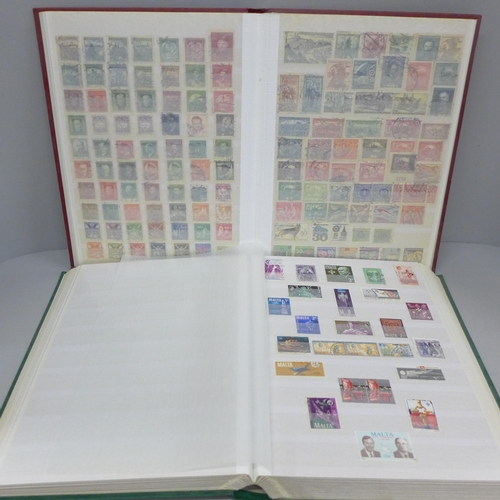 686 - A box file of World stamps in two albums