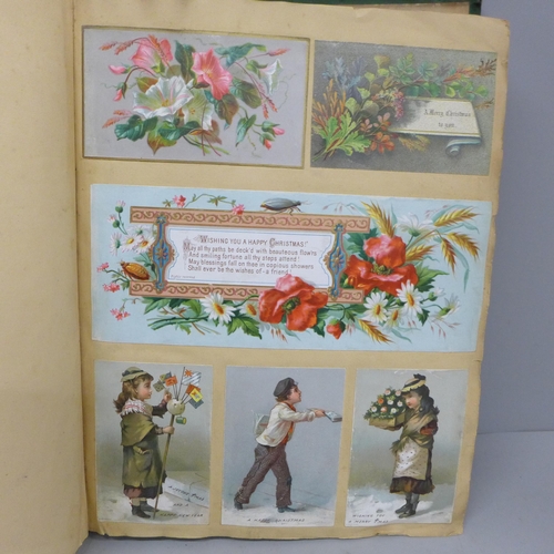 689 - An album of Victorian greeting cards, 240 in total, Christmas, New Year and Birthday, interspersed w... 