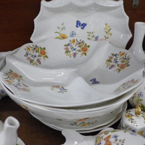 691 - A collection of early Aynsley Cottage Garden china, includes shell shaped dish, three lidded pots, t... 