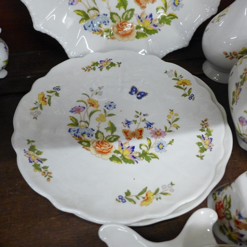 691 - A collection of early Aynsley Cottage Garden china, includes shell shaped dish, three lidded pots, t... 