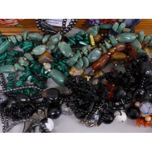 694 - A collection of necklaces, labradorite, coral, Scottish pebble, malachite, in wooden box decorated w... 