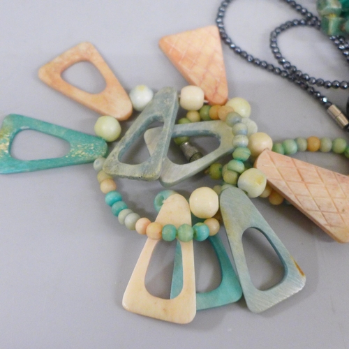 694 - A collection of necklaces, labradorite, coral, Scottish pebble, malachite, in wooden box decorated w... 