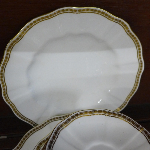 697 - A Royal Crown Derby Carlton Gold six setting tea and dinner service, lacking one side and dinner pla... 