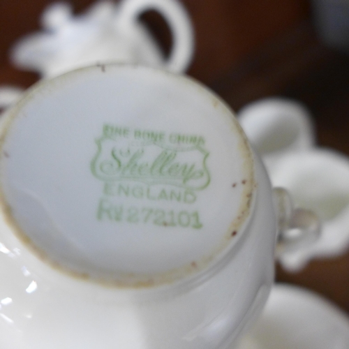 698 - A Royal Crown Derby white four setting coffee set, two Shelley white trios and a white teapot