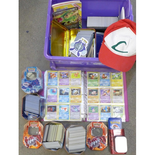 722 - A large collection of Pokemon cards including six tins containing cards, a box of cards, other acces... 