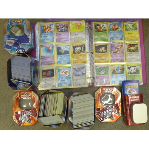 722 - A large collection of Pokemon cards including six tins containing cards, a box of cards, other acces... 