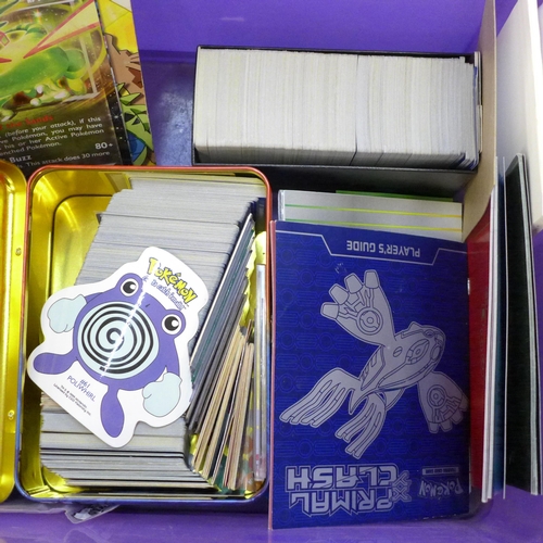 722 - A large collection of Pokemon cards including six tins containing cards, a box of cards, other acces... 