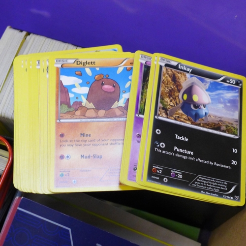 722 - A large collection of Pokemon cards including six tins containing cards, a box of cards, other acces... 