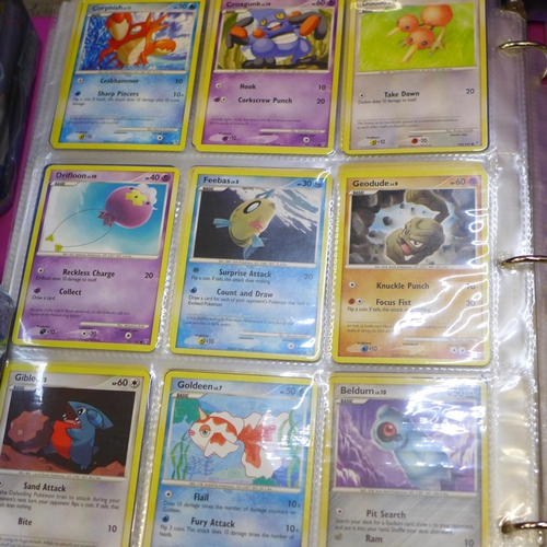 722 - A large collection of Pokemon cards including six tins containing cards, a box of cards, other acces... 