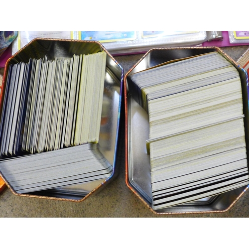 722 - A large collection of Pokemon cards including six tins containing cards, a box of cards, other acces... 