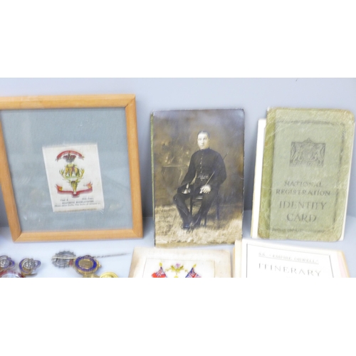 736 - Military related items including silks, badges, buttons, flatware, postcards and a modern wristwatch