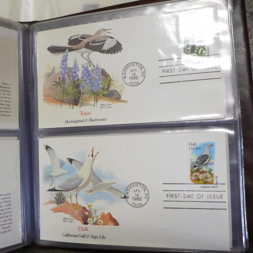 748 - A collection of stamp albums and first day covers including 'Birds & Flowers of the 50 States', and ... 