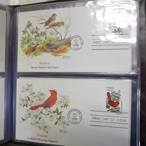 748 - A collection of stamp albums and first day covers including 'Birds & Flowers of the 50 States', and ... 