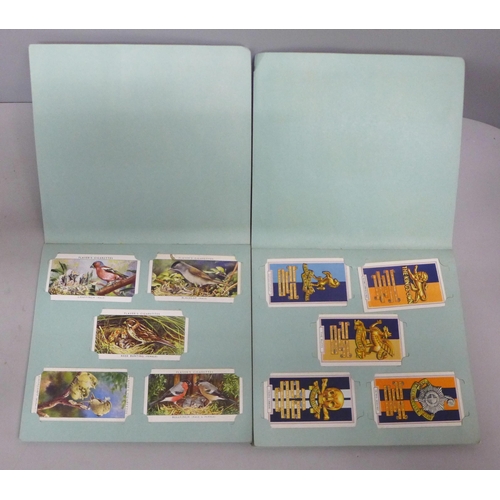 764 - A Players cigarettes set of Birds cards in a picture album, Regimental crests cards in an album, Pla... 