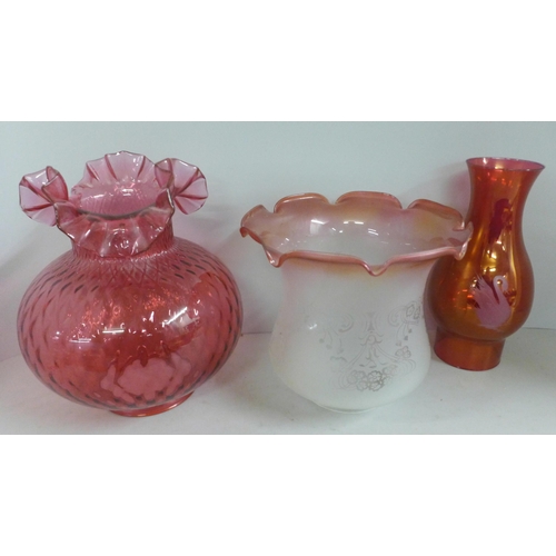 795 - A cranberry glass oil lampshade, one other etched glass shade and an etched pink glass shade