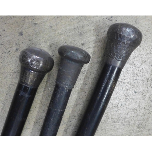 802 - Three silver topped walking canes