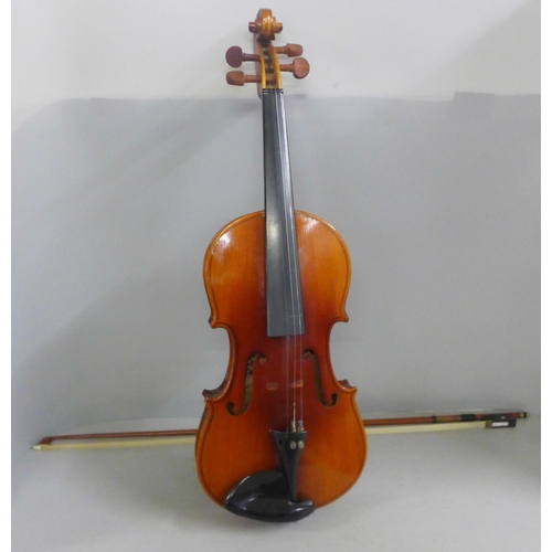 805 - Two cased violins and bows, both backs 33.5cm approximately excluding button