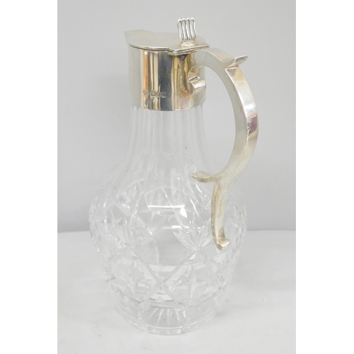 819 - A silver topped glass claret jug, Goldsmiths and Silversmiths