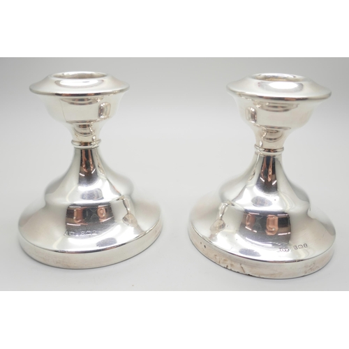 823 - A matched pair of silver dwarf candlesticks