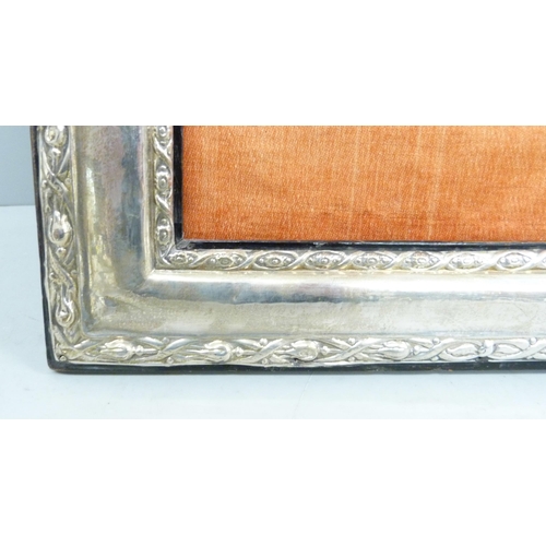 826 - A large silver photograph frame, dented and back stand requires repair, 24cm wide