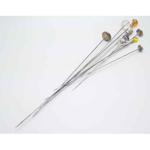 852 - Nine hat pins including two silver