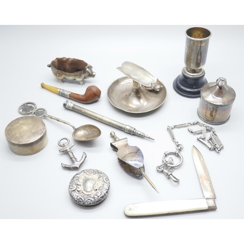 853 - A collection of silver, etc.; including silver pig pin cushion, Birmingham 1905, silver cigar rest, ... 