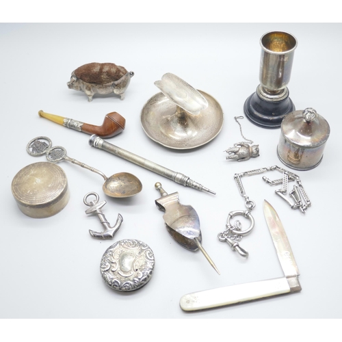 853 - A collection of silver, etc.; including silver pig pin cushion, Birmingham 1905, silver cigar rest, ... 