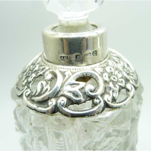 863 - A silver mounted cut glass scent bottle in the shape of a bell, Birmingham 1902, two other silver mo... 