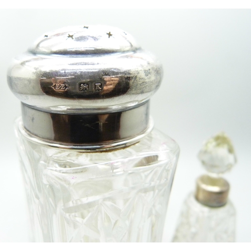 864 - A silver top cut glass shaker, Birmingham 1934, a pair of silver topped salts and a silver mounted s... 