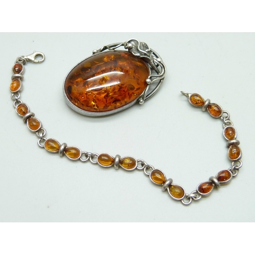 875 - A silver and amber brooch and bracelet