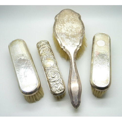 876 - Four silver backed brushes