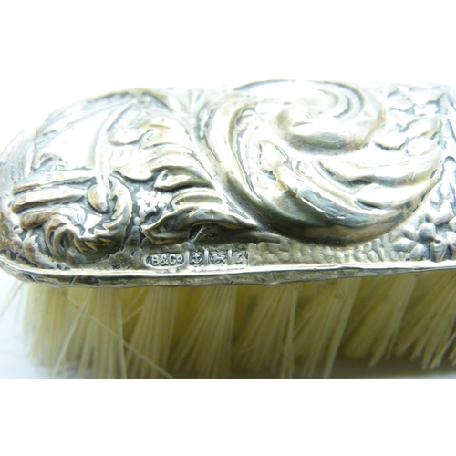 876 - Four silver backed brushes