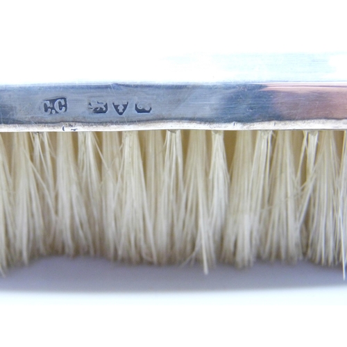 876 - Four silver backed brushes