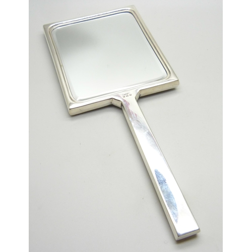 882 - A silver and enamelled hand mirror and two brushes, Birmingham 1950