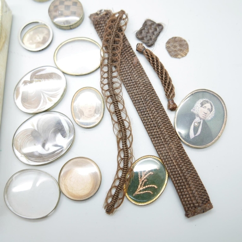 899 - A collection of Victorian brooch inserts, in memory of photographs, hair, etc.