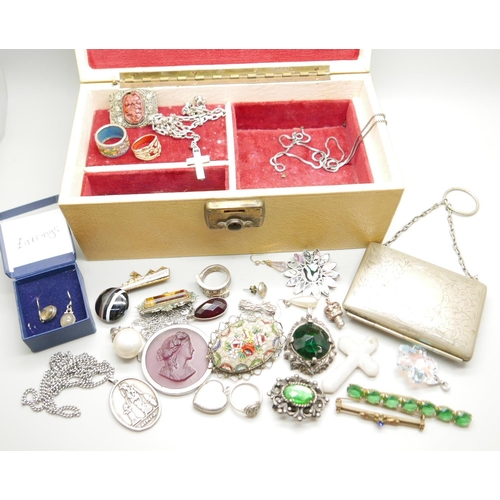 921 - A jewellery box and contents including a silver locket, three chains and ring, and a plated purse