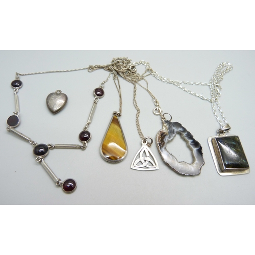 936 - A silver necklace, a silver locket, a silver and tigers eye pendant and chain, other chains and thre... 