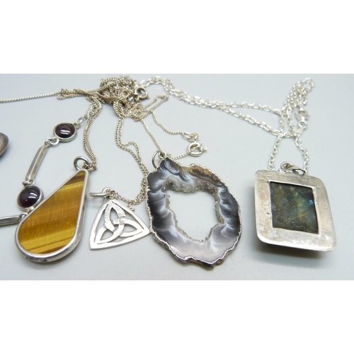 936 - A silver necklace, a silver locket, a silver and tigers eye pendant and chain, other chains and thre... 