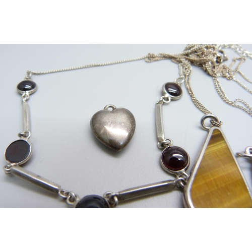 936 - A silver necklace, a silver locket, a silver and tigers eye pendant and chain, other chains and thre... 