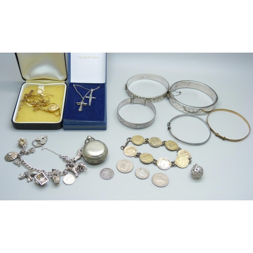 946 - Silver jewellery including four silver bangles and a silver charm bracelet, coins and a sovereign ho... 