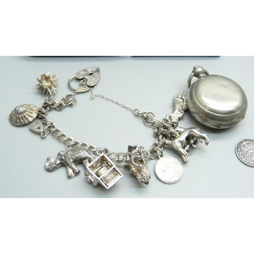 946 - Silver jewellery including four silver bangles and a silver charm bracelet, coins and a sovereign ho... 