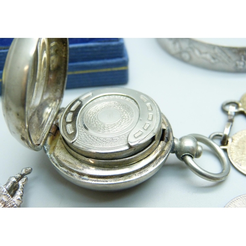 946 - Silver jewellery including four silver bangles and a silver charm bracelet, coins and a sovereign ho... 