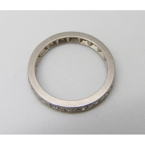 986 - A white metal and diamond eternity ring, 3.4g, L